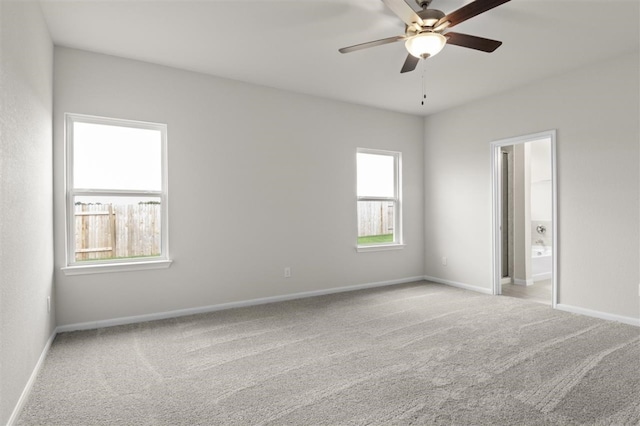 unfurnished room featuring light colored carpet and ceiling fan