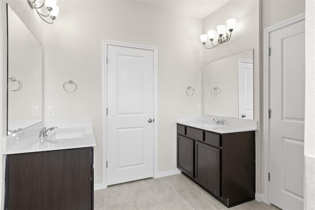 bathroom featuring tile patterned flooring, vanity, and a notable chandelier