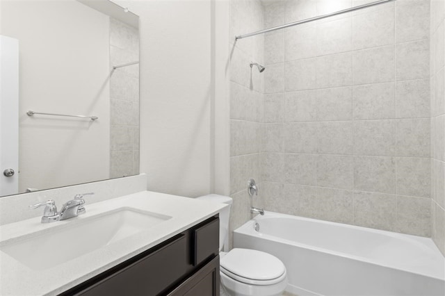 full bathroom featuring toilet, vanity, and tiled shower / bath