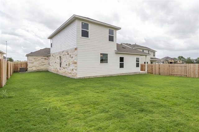 back of house featuring cooling unit and a lawn