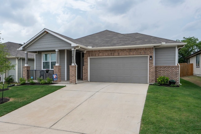 view of front facade featuring a garage, a front lawn, and a porch