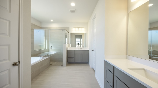 bathroom featuring separate shower and tub and vanity