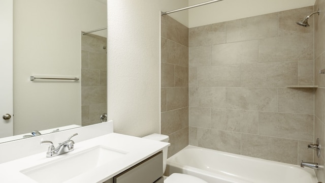 full bathroom with vanity, toilet, and tiled shower / bath