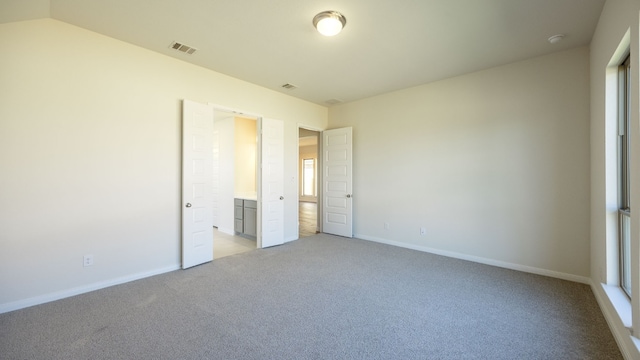 unfurnished bedroom with light colored carpet