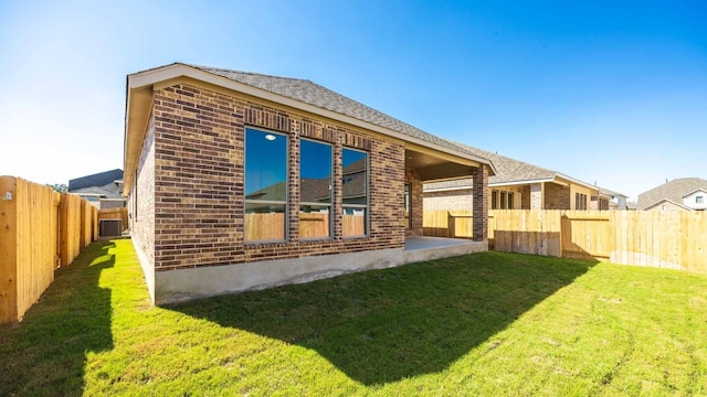 rear view of property featuring a yard