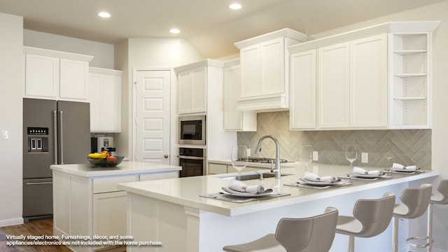 kitchen with appliances with stainless steel finishes, decorative backsplash, white cabinetry, and dark hardwood / wood-style floors