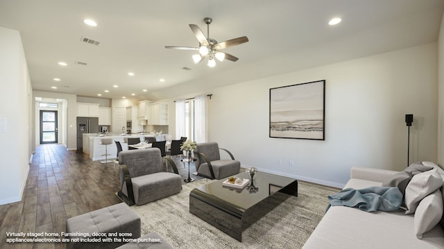 living room with ceiling fan and hardwood / wood-style flooring