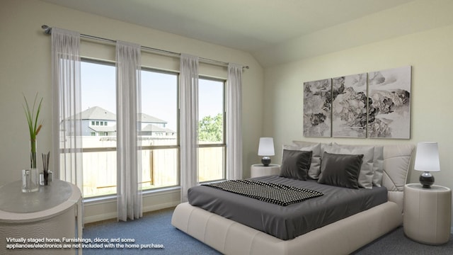 carpeted bedroom featuring lofted ceiling and multiple windows