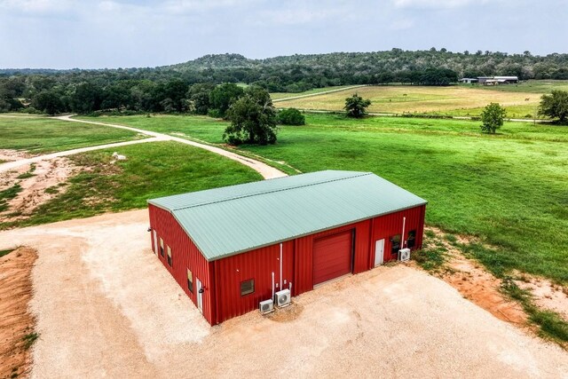 exterior space featuring a rural view and an outdoor structure