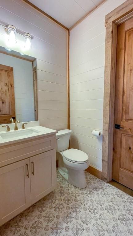 bathroom featuring vanity, ornamental molding, and toilet