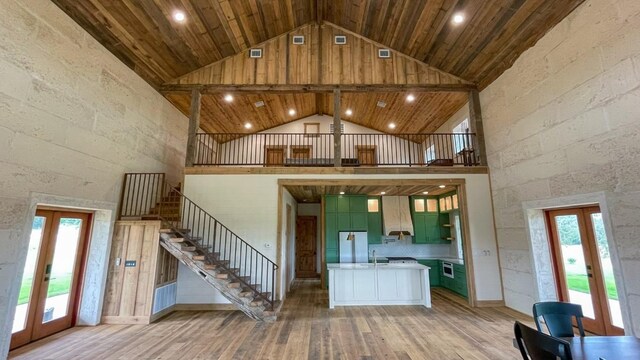 interior space with light hardwood / wood-style floors, wooden ceiling, high vaulted ceiling, and french doors