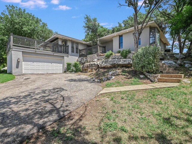 view of front of property with a balcony and a garage