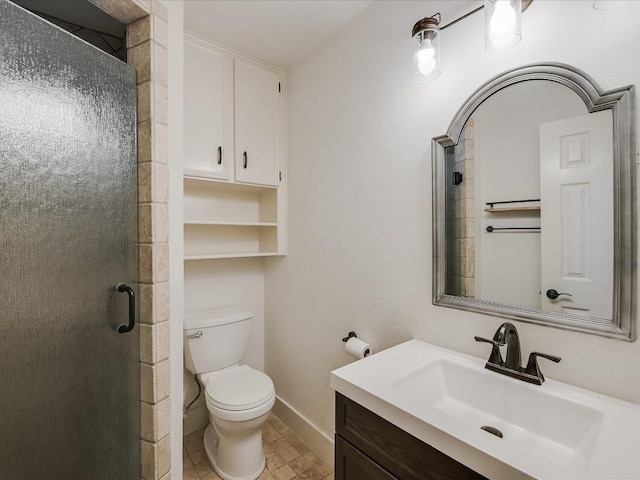 bathroom with baseboards, a shower stall, toilet, and vanity