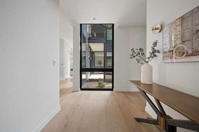 hall with light hardwood / wood-style floors