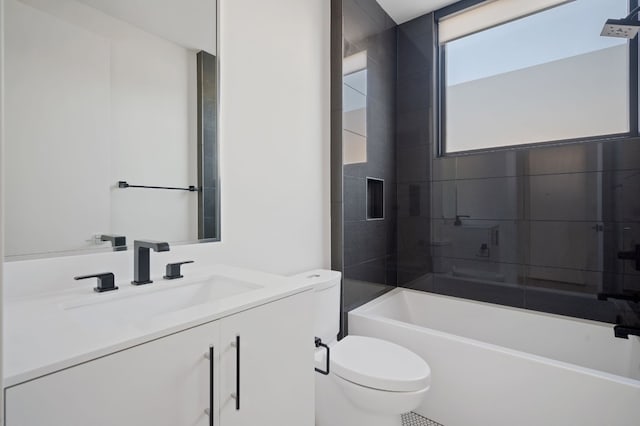 full bathroom with vanity, toilet, and tiled shower / bath combo