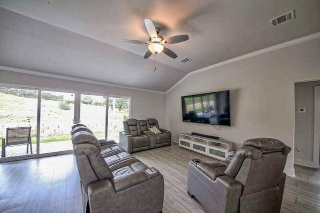 living room with ceiling fan, crown molding, light hardwood / wood-style flooring, and vaulted ceiling