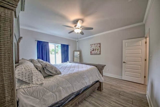 bedroom with hardwood / wood-style floors, ceiling fan, and ornamental molding