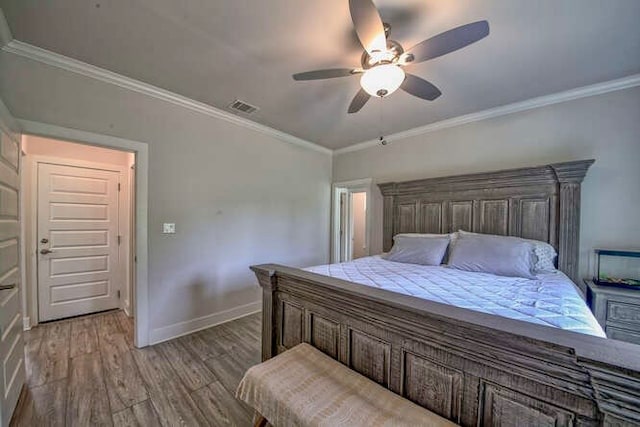 bedroom with hardwood / wood-style floors, ceiling fan, and crown molding