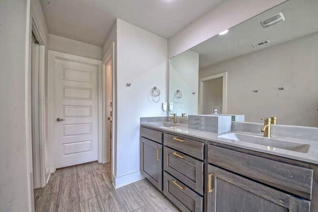 bathroom featuring vanity and hardwood / wood-style flooring