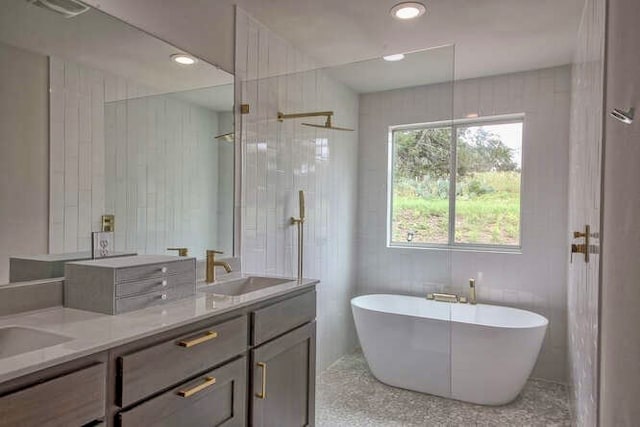 bathroom with vanity and separate shower and tub