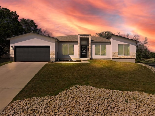 view of front of house featuring a garage and a yard