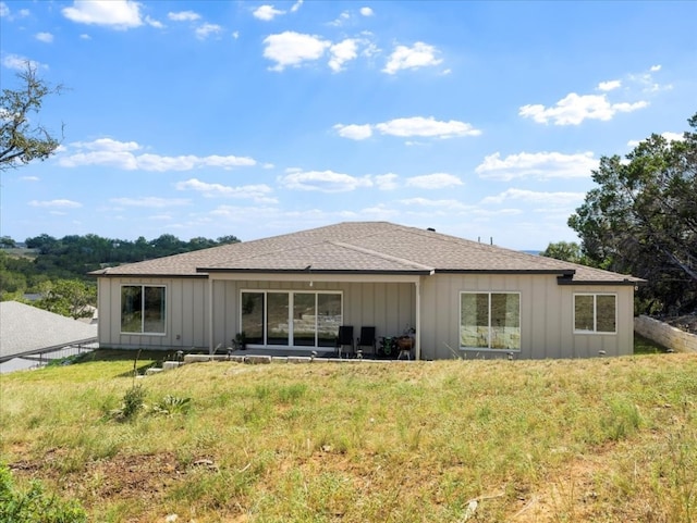 back of property featuring a yard