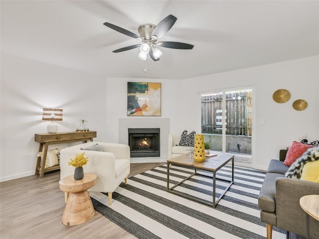 living room with ceiling fan and light hardwood / wood-style floors