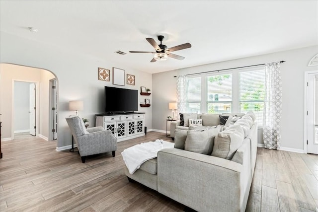 living room with ceiling fan and light wood-type flooring