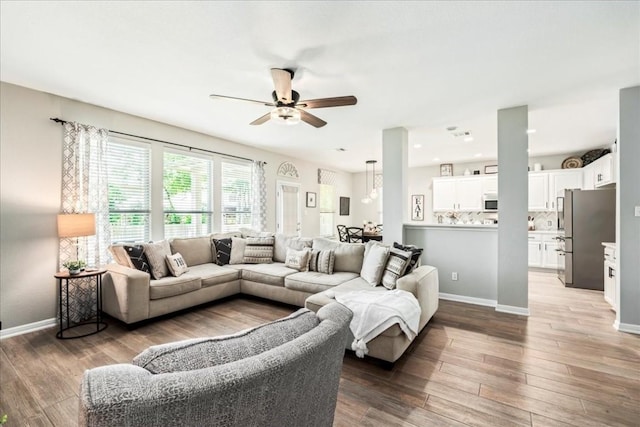 living room featuring hardwood / wood-style flooring and ceiling fan