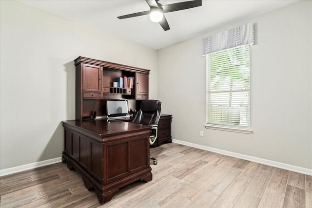 office space featuring ceiling fan, a healthy amount of sunlight, and light hardwood / wood-style floors