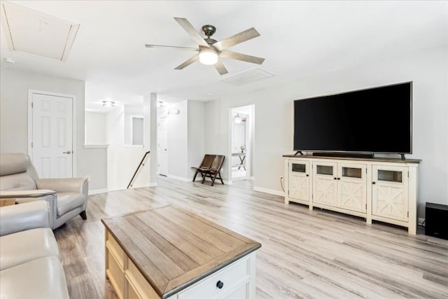 living room with ceiling fan and light hardwood / wood-style floors