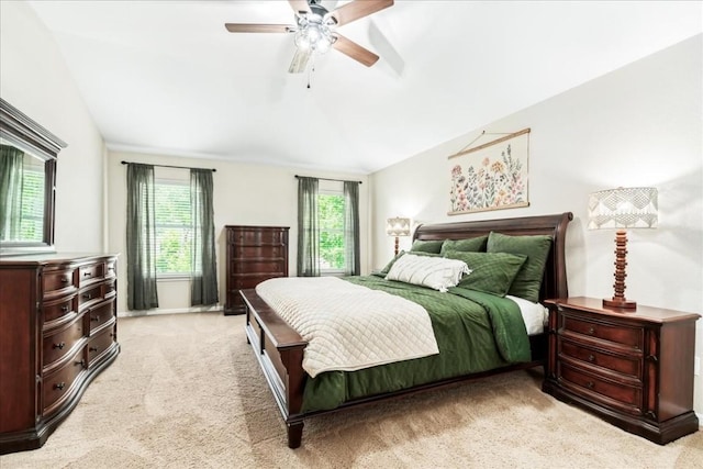 bedroom with ceiling fan, light carpet, and vaulted ceiling