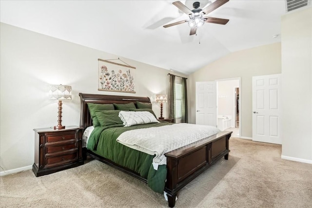 carpeted bedroom featuring ceiling fan, ensuite bathroom, and vaulted ceiling