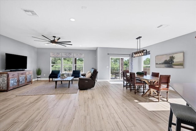 living room featuring light wood-type flooring and ceiling fan