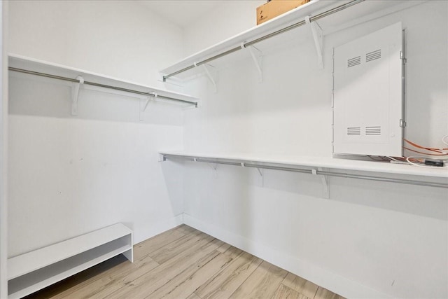 spacious closet with light hardwood / wood-style flooring