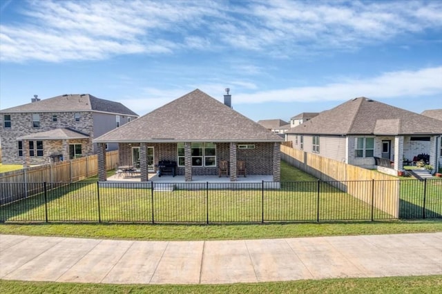 back of house featuring a lawn and a patio