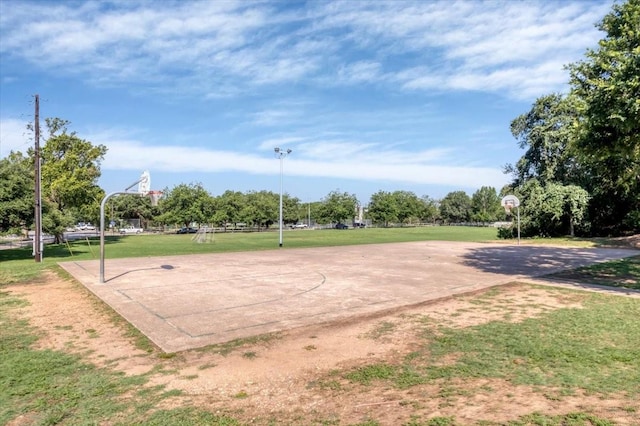 view of community featuring a yard and basketball hoop