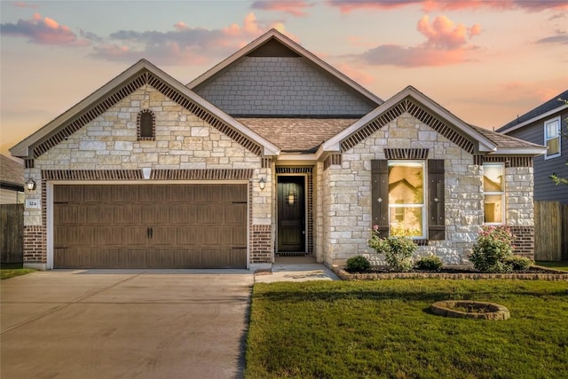 view of front of home with a yard and a garage