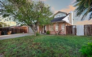 view of property with a garage and a yard