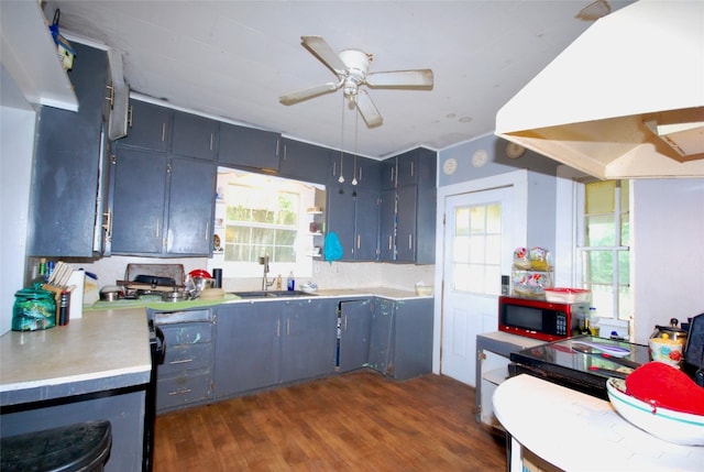 kitchen featuring island exhaust hood, sink, dark hardwood / wood-style flooring, and ceiling fan