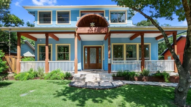 exterior space with covered porch and a lawn