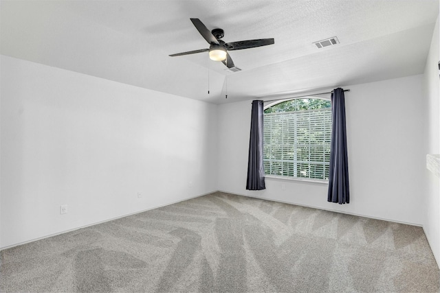 unfurnished room featuring ceiling fan and carpet