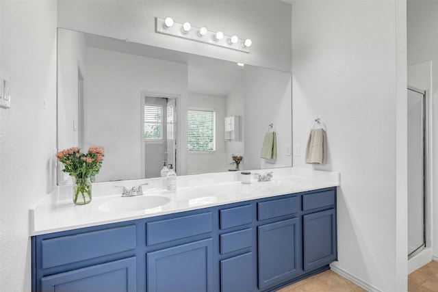 bathroom featuring walk in shower, tile patterned flooring, and vanity