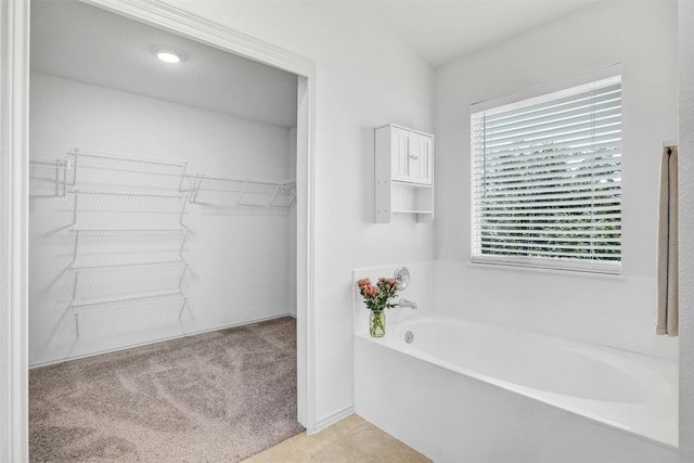 bathroom featuring a tub and tile patterned flooring