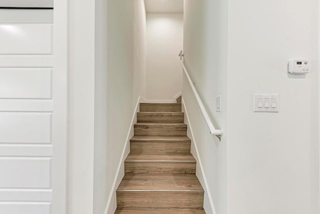 stairs featuring hardwood / wood-style flooring