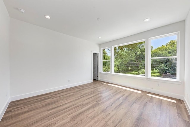 empty room with light hardwood / wood-style flooring