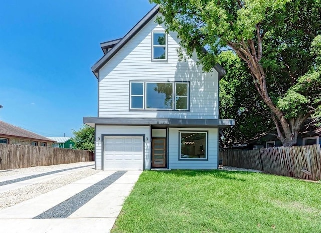 view of front of property with a front lawn and a garage