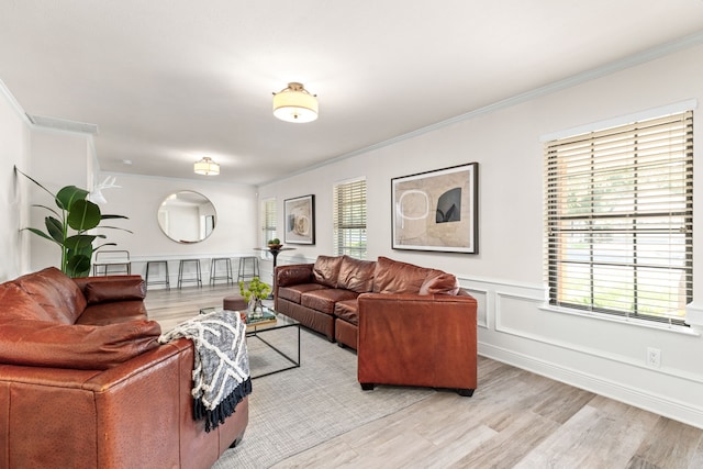 living room featuring crown molding and light wood-type flooring