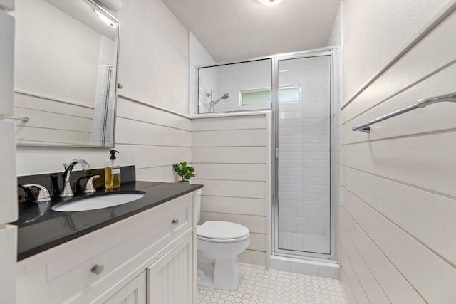 bathroom with toilet, vanity, and an enclosed shower