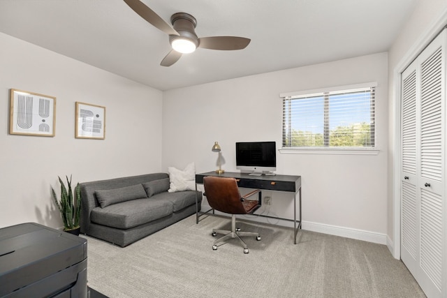 carpeted office space featuring ceiling fan